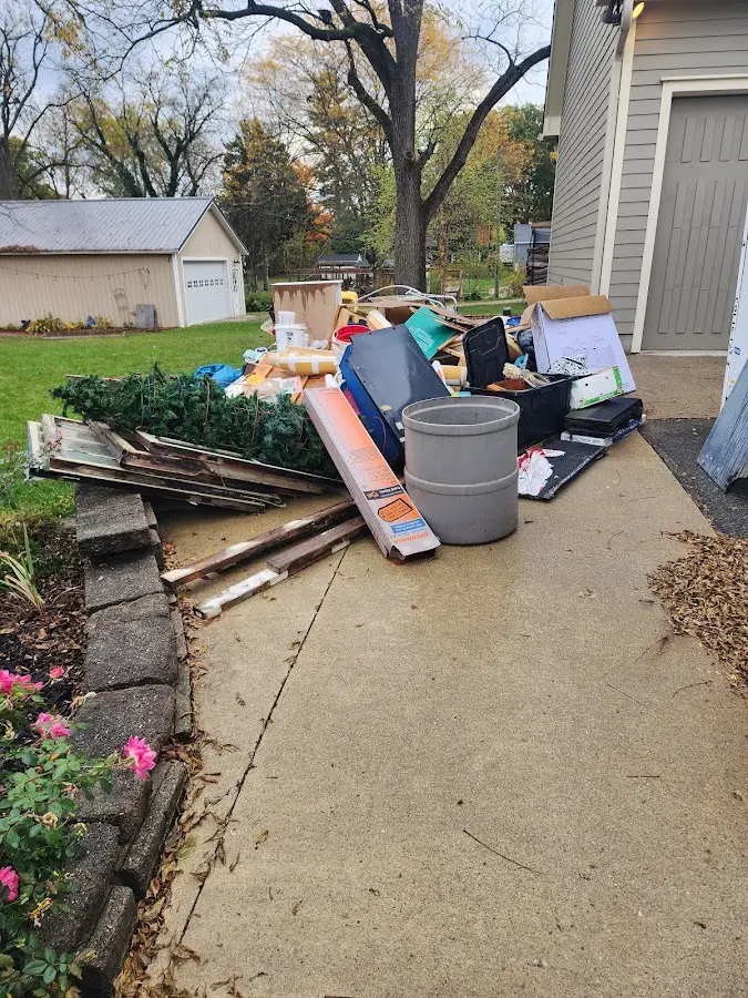 Dumpster being loaded with debris for Residential Dumpster Rental in St. Clair